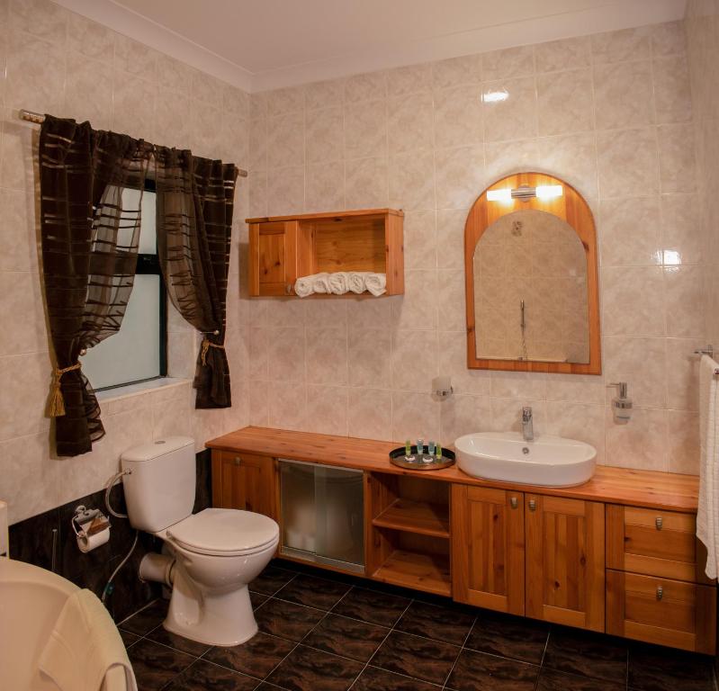 a bathroom with a toilet and a sink at Spacious 3 bedroom apartment in Marsascala in Marsaskala