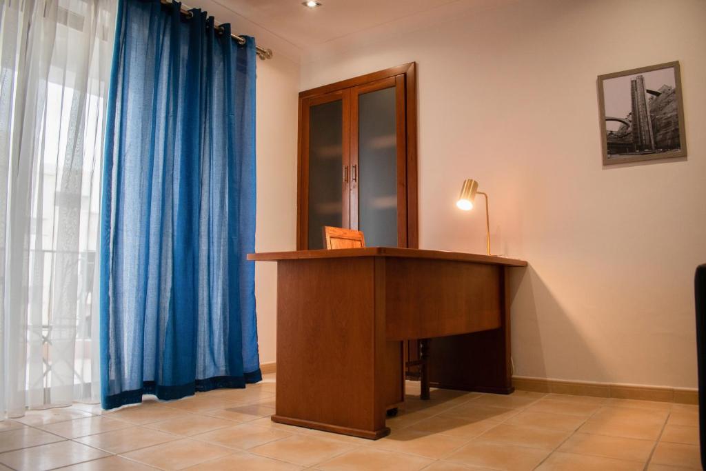 a wooden podium in a room with blue curtains at Spacious 3 bedroom apartment in Marsascala in Marsaskala