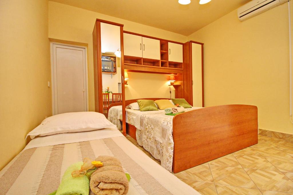 sypialnia z dwoma łóżkami i lustrem w obiekcie Apartments Sea Line w mieście Prigradica