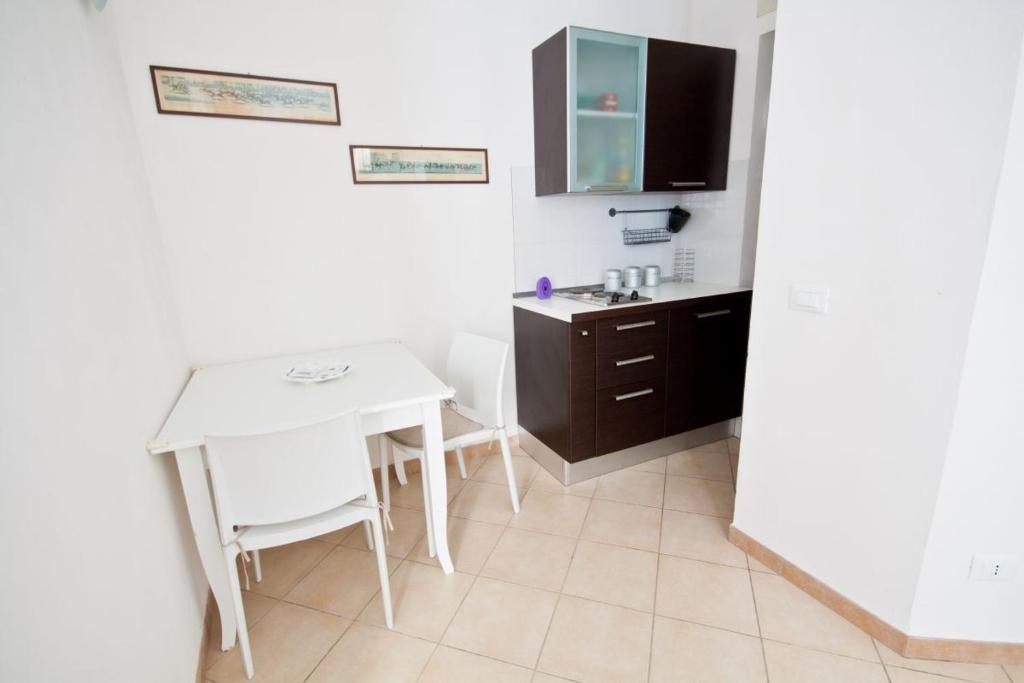 a kitchen with a white table and a sink at Al Vicoletto in Trapani