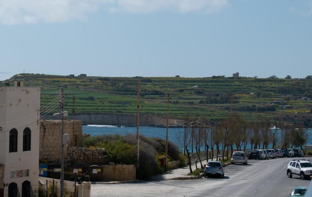 a street with cars parked on the side of a road at Spacious 3 bedroom apartment in Marsascala in Marsaskala