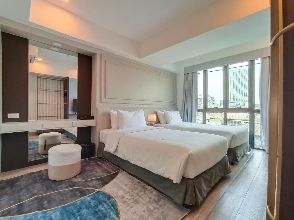 Postel nebo postele na pokoji v ubytování VIVA LA VIDA HOTEL