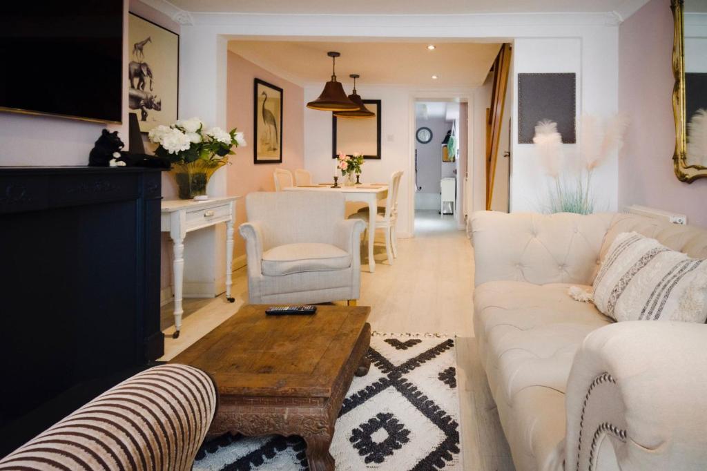 a living room with a white couch and a table at Salt Life Cottage in Brighton & Hove