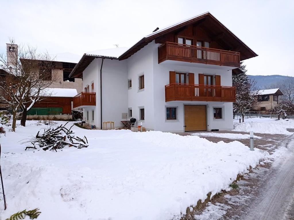 a house with snow in front of it at Casa nel verde in Comano Terme