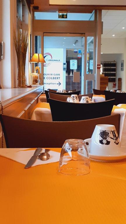 a table with a plate of food on top of it at The Originals City, Hôtel Colmar Gare in Colmar