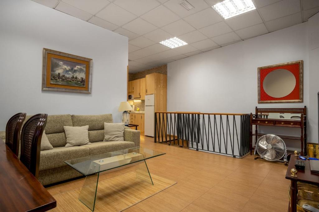een woonkamer met een bank en een glazen tafel bij 2 bedrooms 1,5 bathrooms furnished - Malasaña - Cozy & Vintage - Minty Stay in Madrid