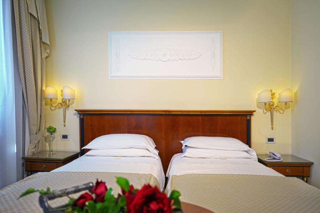 Postel nebo postele na pokoji v ubytování Hotel Aurora Terme