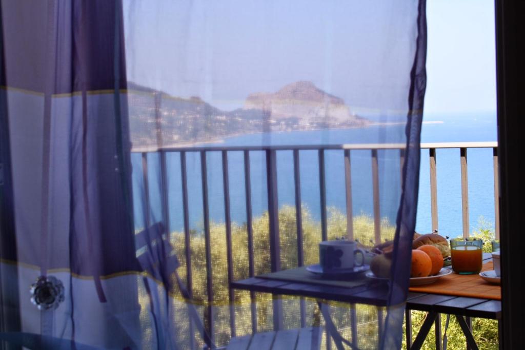 - un balcon avec une table et une vue sur l'océan dans l'établissement Belvedere Sant'Ambrogio, à Cefalù