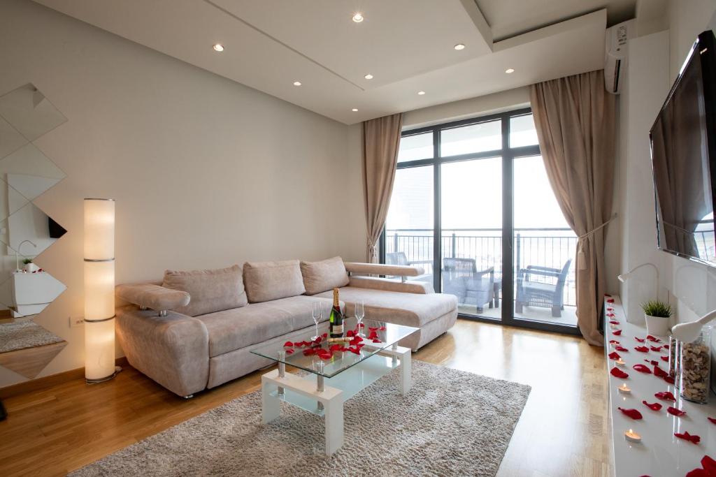ein Wohnzimmer mit einem Sofa und einem Tisch in der Unterkunft Belgrade Waterfront Apartments - River View in Belgrad