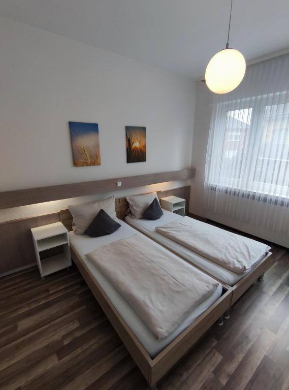 a bedroom with a large bed in a room at Gästehaus am Bahnhof, Self Check In in Vechta