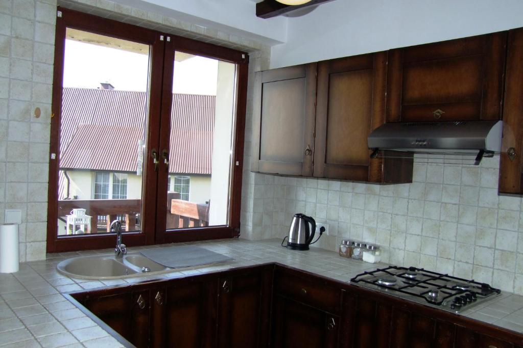 Kuchyň nebo kuchyňský kout v ubytování Mazurski Zakątek-Apartamenty