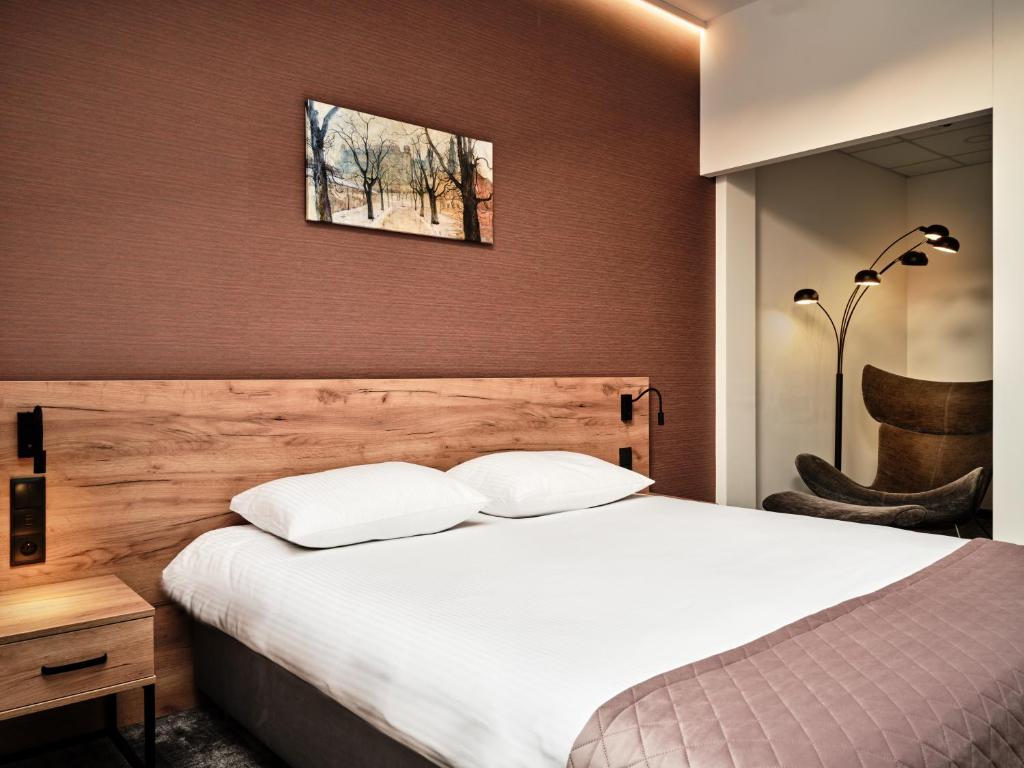 Postel nebo postele na pokoji v ubytování 1891 Garni Hotel
