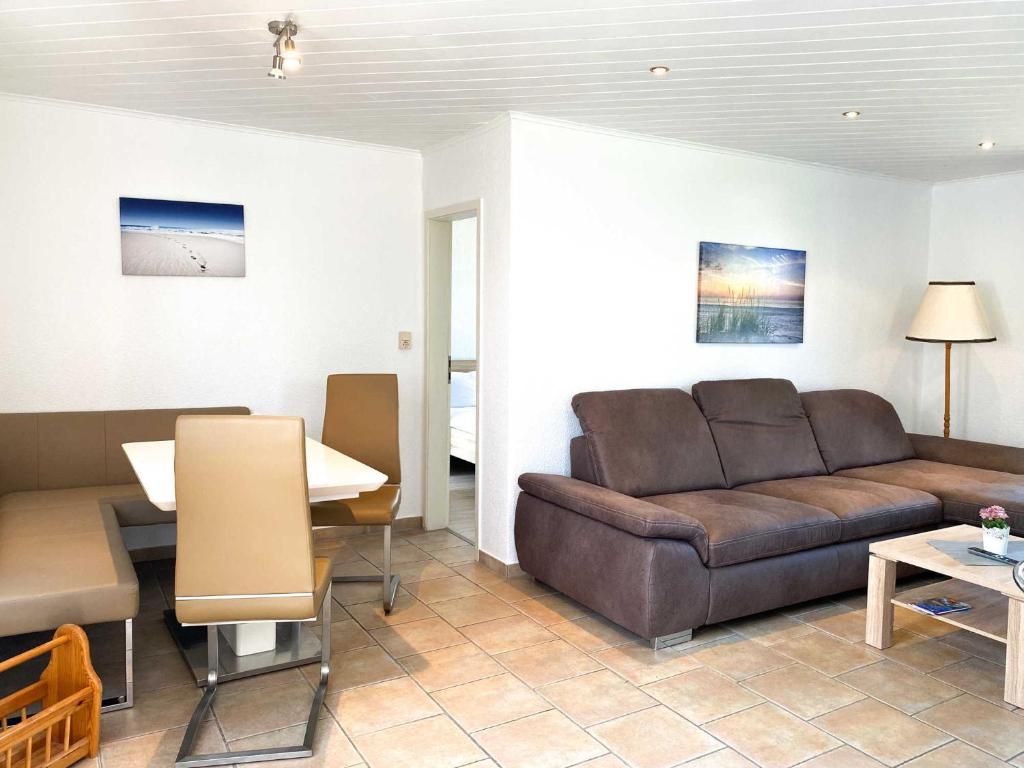 a living room with a couch and a table at Boddenwind No 3 in Zingst