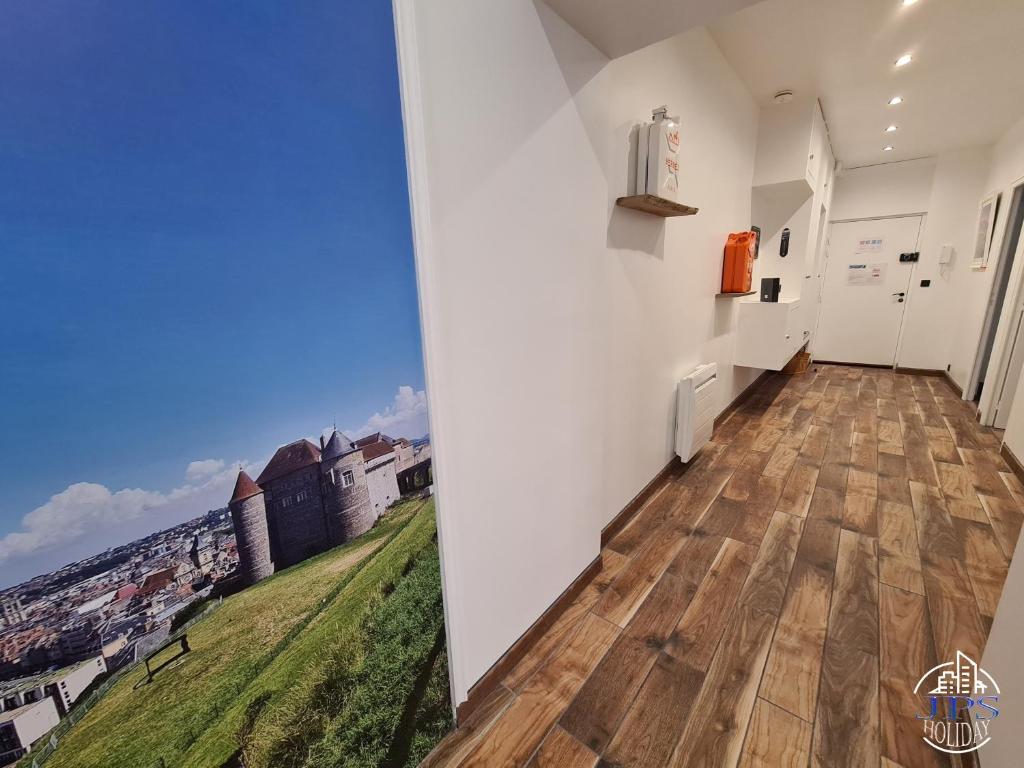 a hallway with a room with a view of a city at Quintessence By JPS Holiday, Splendide appartement au coeur de Dieppe in Dieppe