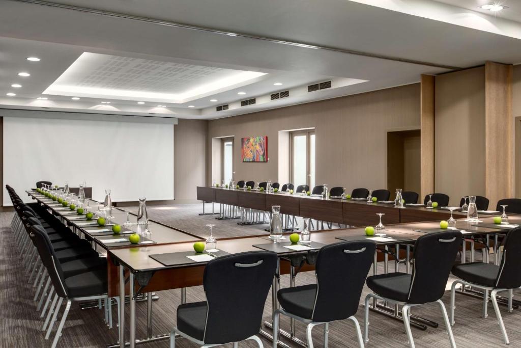 a conference room with a long table and chairs at NH Brugge in Bruges
