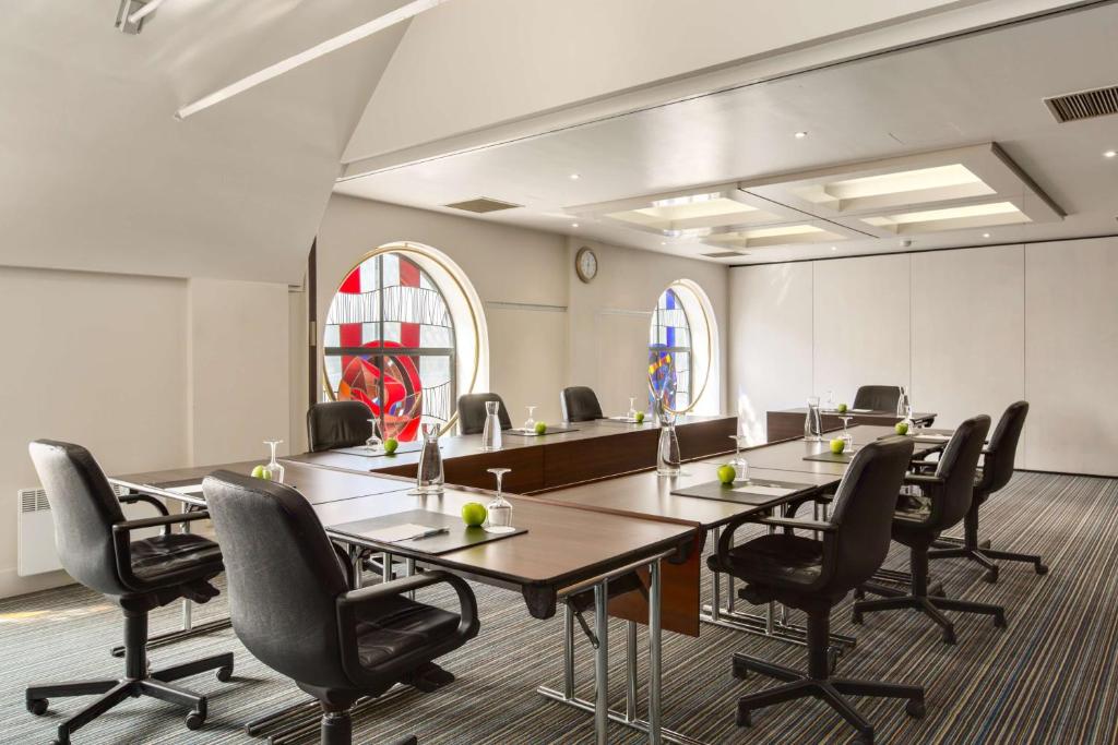 a conference room with a long table and chairs at NH Brugge in Bruges