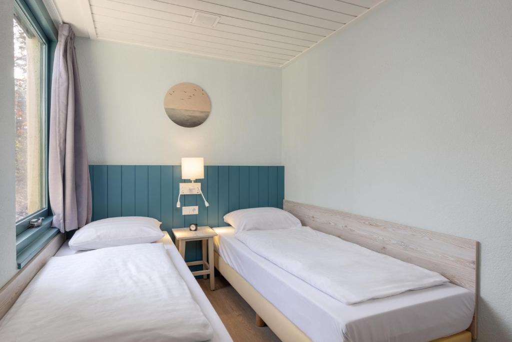 Postel nebo postele na pokoji v ubytování Center Parcs Vossemeren