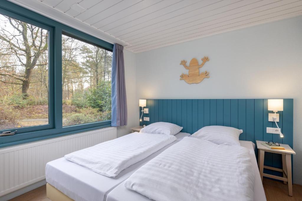 Postel nebo postele na pokoji v ubytování Center Parcs Vossemeren