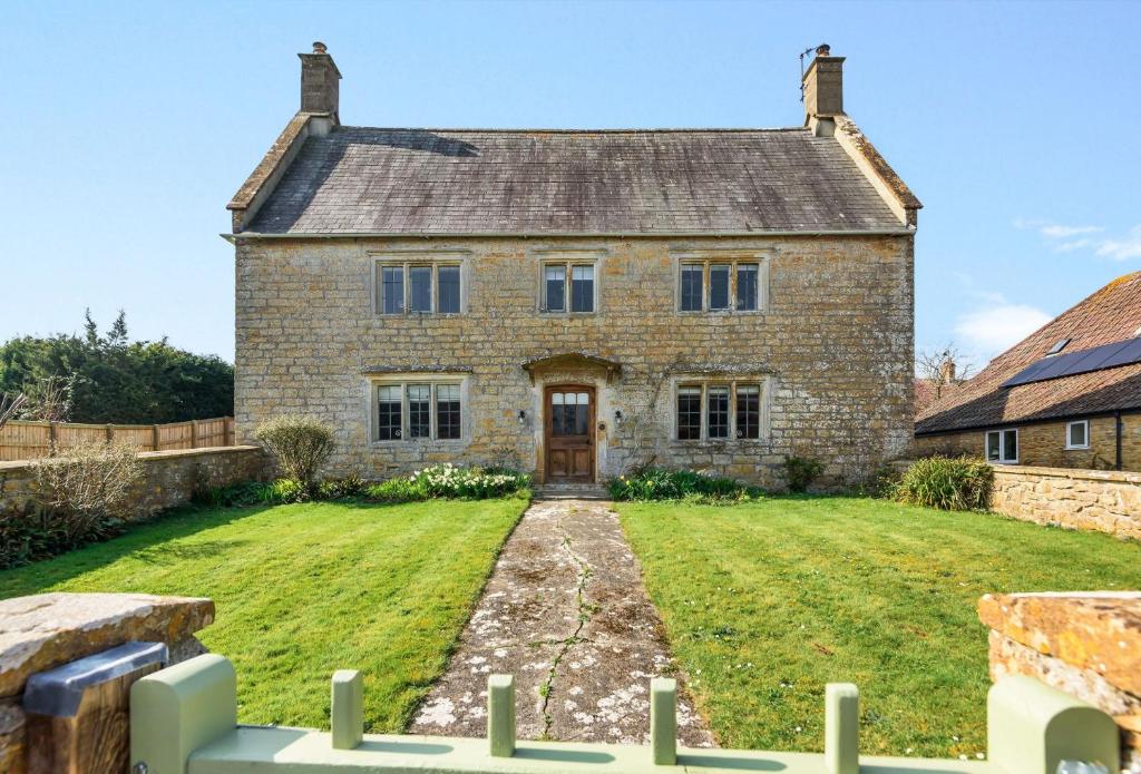 an old brick house with a large yard at Lower Farm in Sherborne