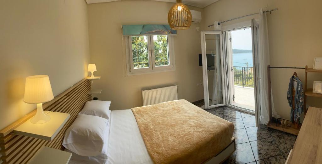 a bedroom with a bed and a window at SEA VIEW DREAM in Argostoli