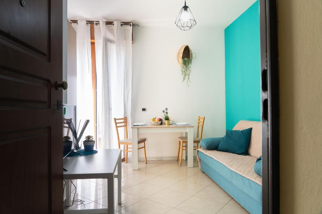 a living room with a blue couch and a table at Residence Yellow in Rimini