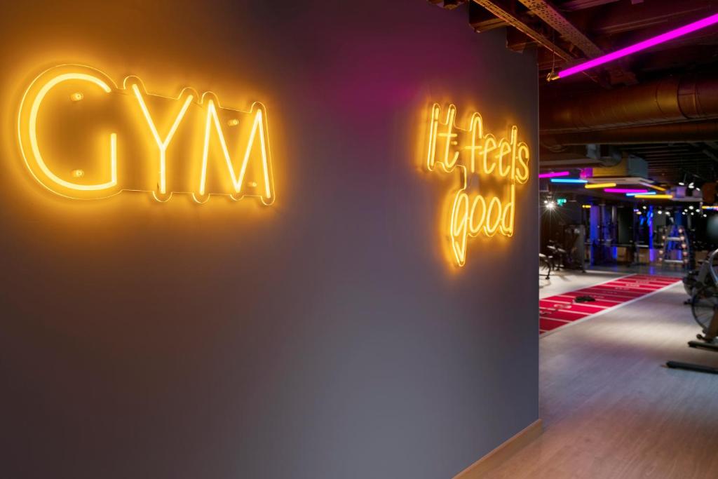 a sign for theres a gym on a wall at Leonardo Royal Hotel Birmingham in Birmingham