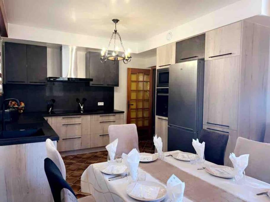 a kitchen with a table and chairs in a kitchen at EVASION gîtes et spa in Saint-Léonard