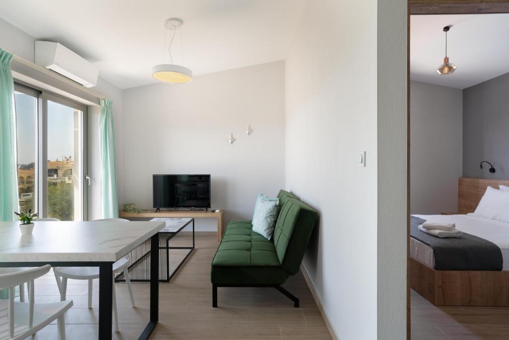 a living room with a bed and a table and a dining room at Sarah Luxury Rooms in Syvota