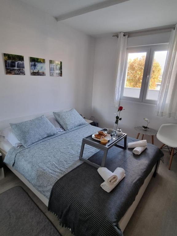 a bedroom with a bed with a tray of food on it at Saint Blaise Apartment in Dubrovnik