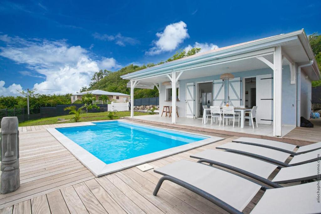 a villa with a swimming pool and a pavilion at Villa Kaliemma in Le Marin