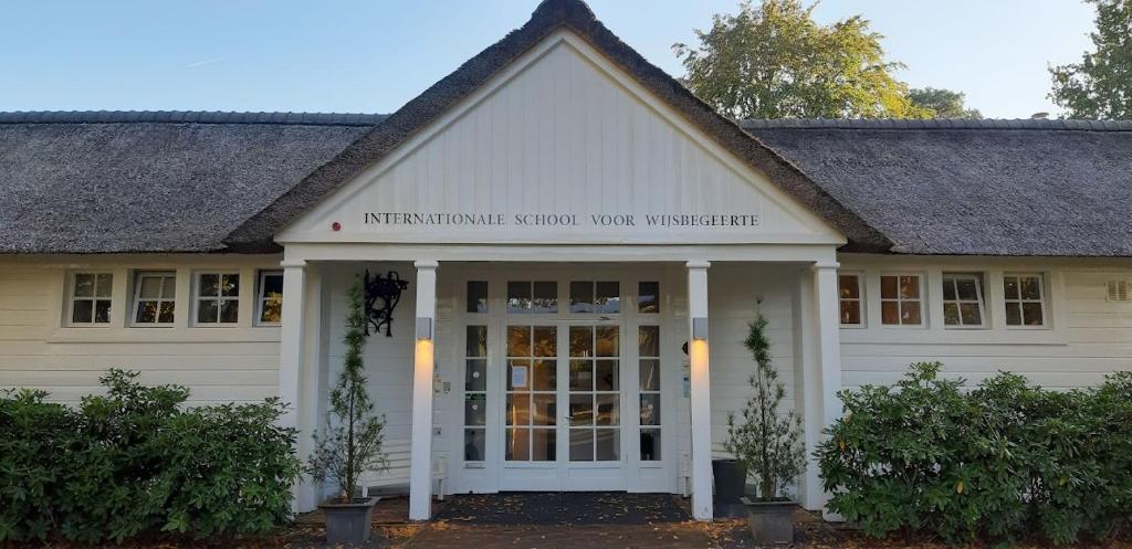 a school building with a sign on the front of it at Landgoed ISVW in Leusden