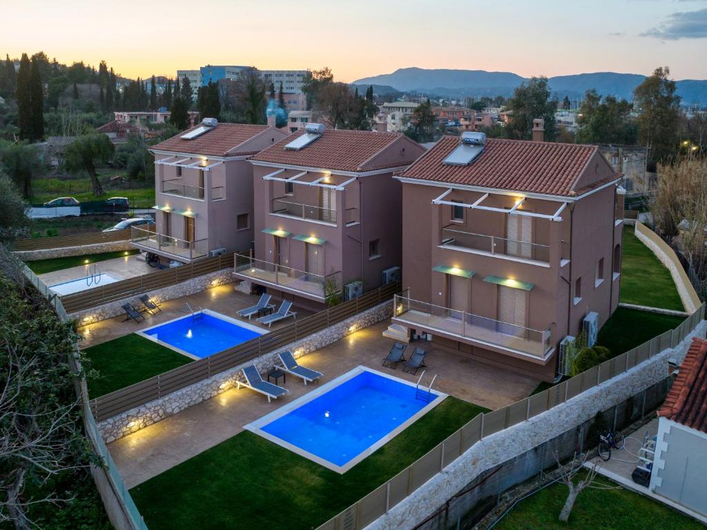 an aerial view of a house with two swimming pools at Efilenia Luxury Villas in Corfu Town