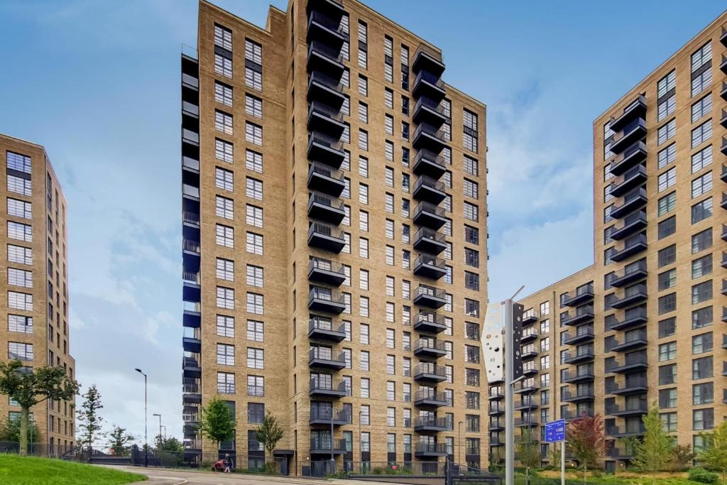 two tall buildings with balconies in a city at Ferrum at Wembley Park - NY Warehouse Loft Style in London