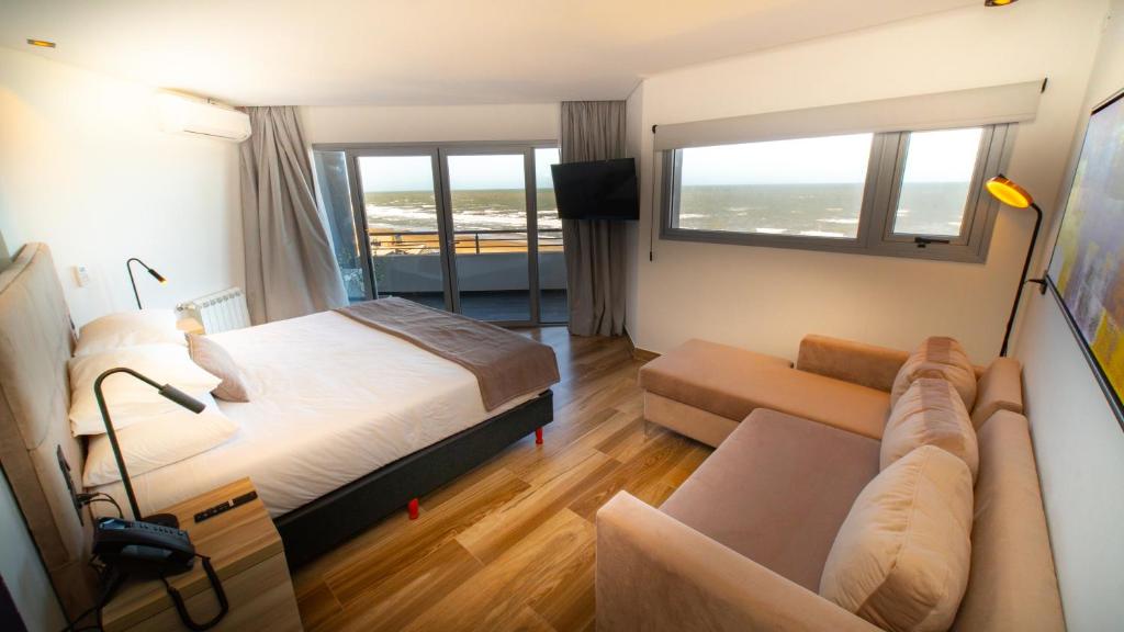 a hotel room with a bed and a couch at Neco Boutique Hotel in San Bernardo