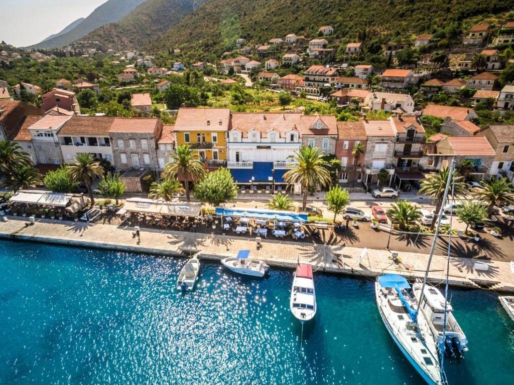 an aerial view of a resort with boats in the water at Guesthouse Aurora in Trpanj