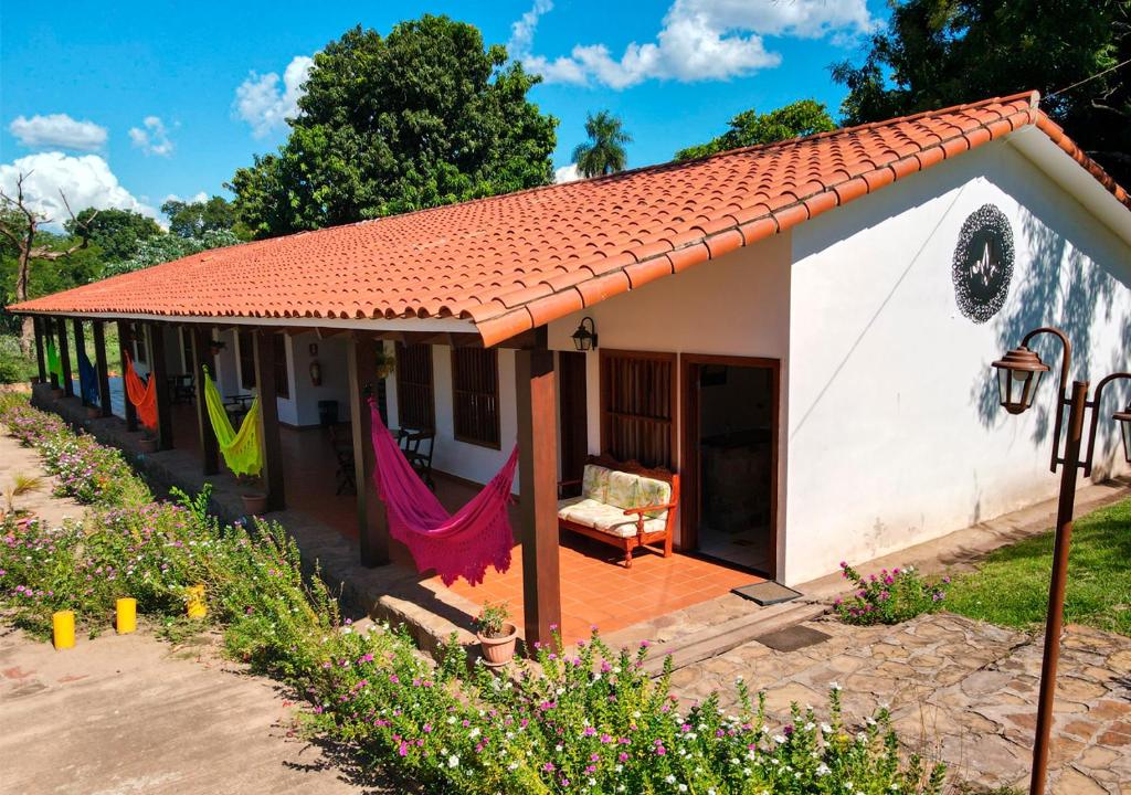 a small house with a hammock outside of it at Hotel Mami Vilma in Roboré
