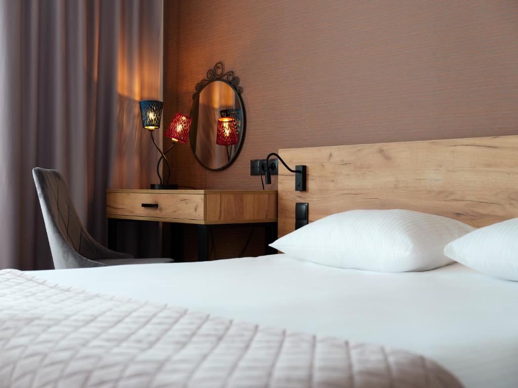 Postel nebo postele na pokoji v ubytování 1891 Garni Hotel