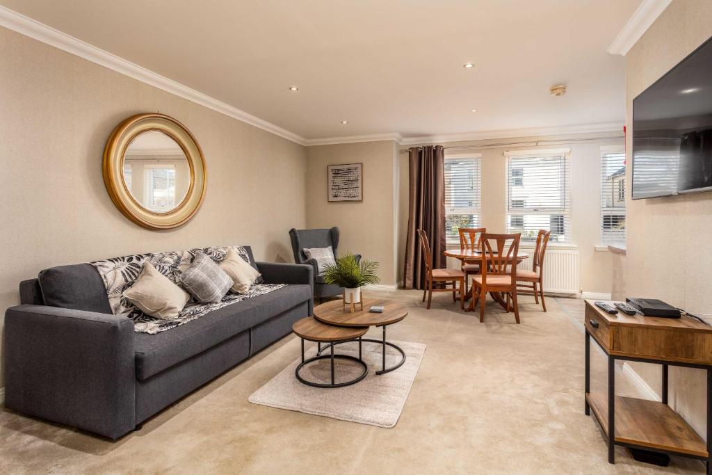 a living room with a couch and a table at London Gate No1 - Donnini Apartments in Kilmarnock