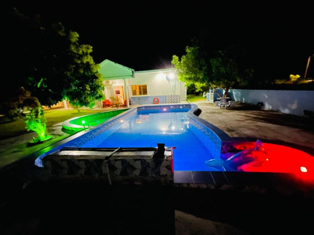 a swimming pool in a yard at night at PD Best Homestay in Port Dickson