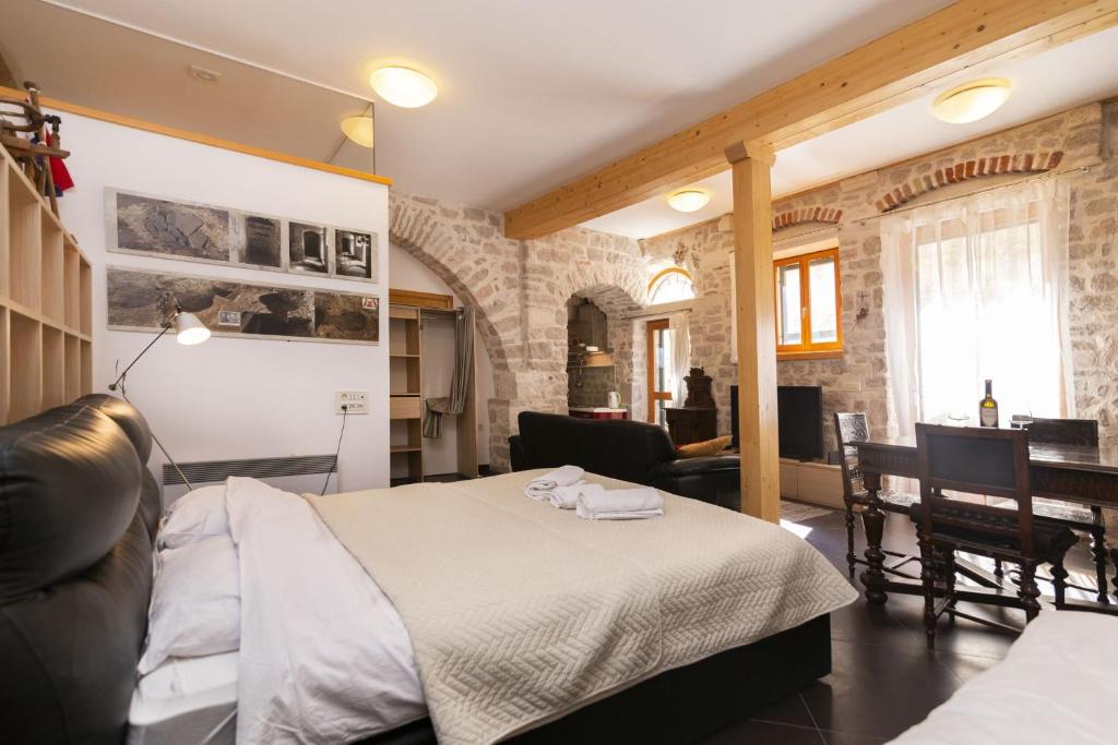 a bedroom with a bed and a dining room at Galera in Šibenik