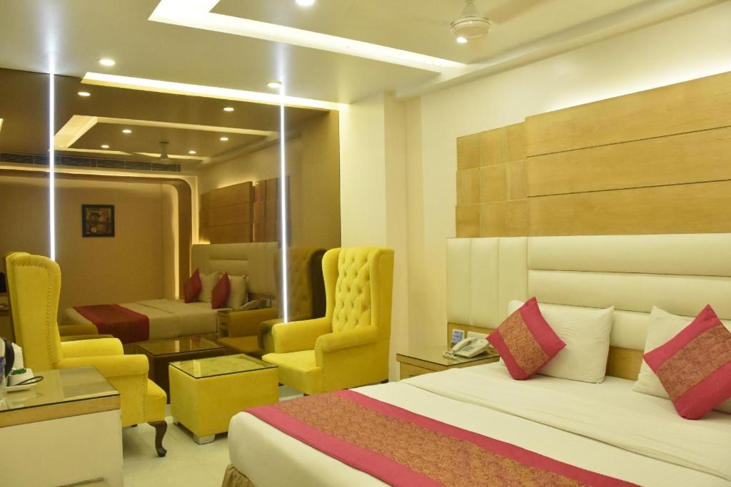 una habitación de hotel con una cama y una sala de espera en Hotel Aman Continental - Paharganj en Nueva Delhi