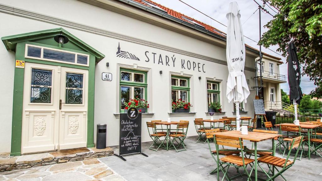 a restaurant with tables and chairs in front of a building at Penzion a bistro Starý kopec in Znojmo