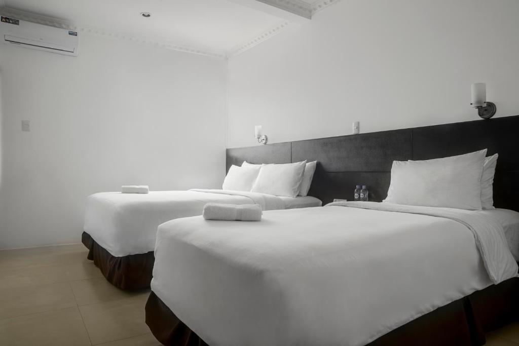 Postel nebo postele na pokoji v ubytování Hotel La Ría Playas