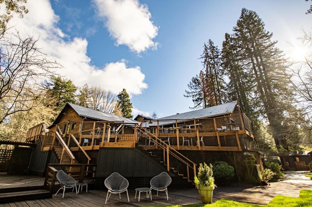 a large wooden house with a deck and chairs at Dawn Ranch in Guerneville