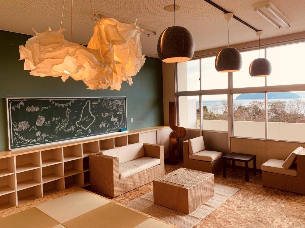 a waiting room with chairs and a chalkboard at Agri Museum NADA - Vacation STAY 40517v in Minamiawaji