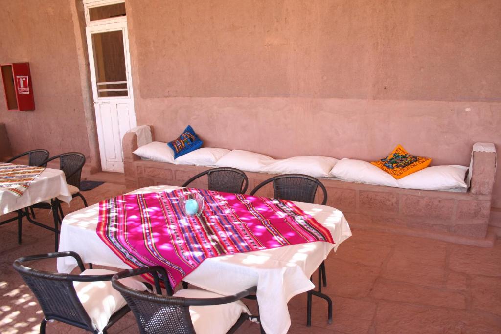 a table and chairs with a couch in a room at Quinta Adela Bed & Breakfast in San Pedro de Atacama