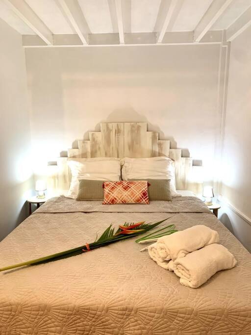 um quarto com uma cama grande com flores em SOMPTUEUX DUPLEX SUR LA ROUTE DES PLAGES em Sainte-Anne