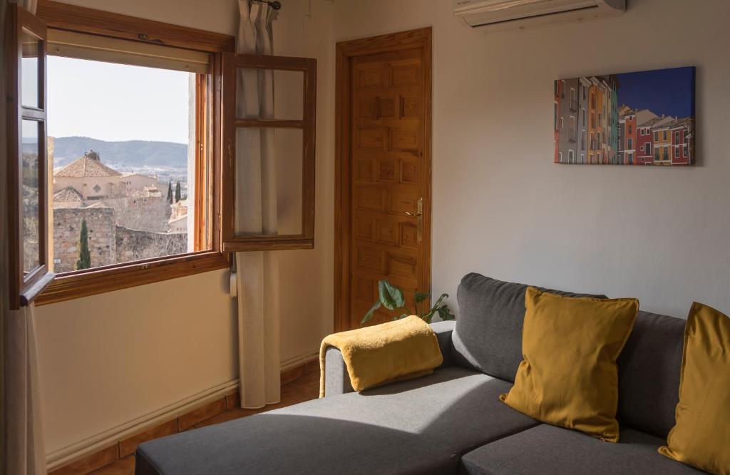a living room with a couch and a window at CUENCALOFT EL CASTILLO in Cuenca