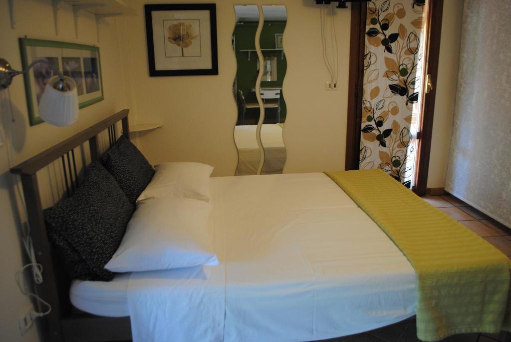 Postel nebo postele na pokoji v ubytování B&B Al Castagneto
