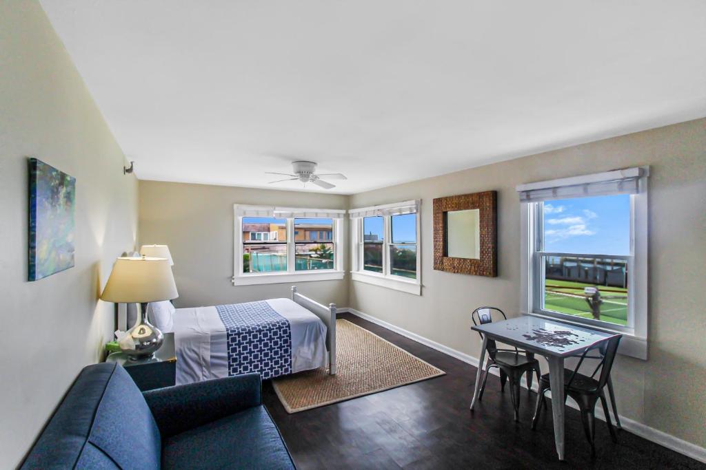 a living room with a couch and a bed and a table at Clegg's Hotel in Ocean Beach